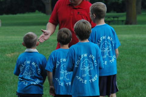 Children Speaking to an Apple Tree staff member