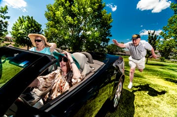Women in a convertible being chased by a man